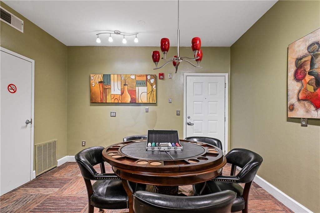 10 Perimeter Summit Boulevard, Unit 3311 Atlanta, GA 30319 - Photo 22 of 68 a dining room with furniture and wooden floor
