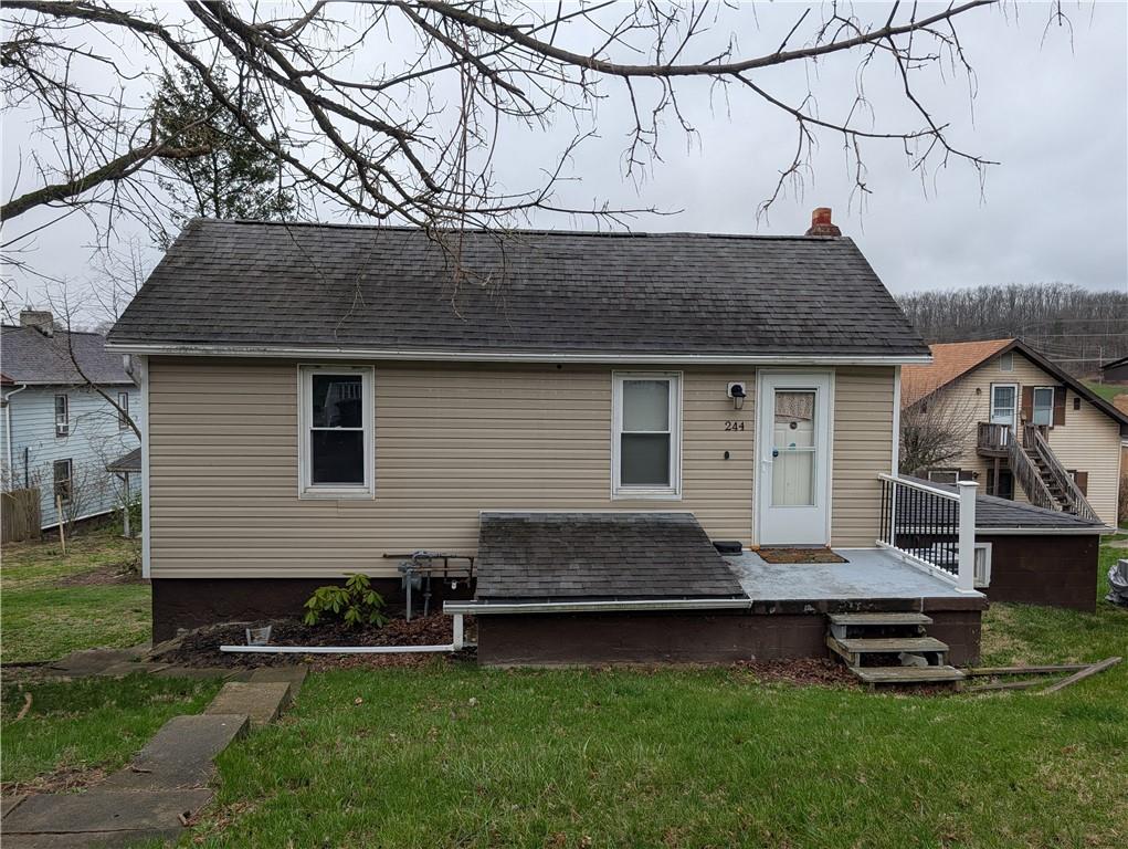 244 North Main Street Houston, PA 15342 - Photo 2 of 3 a front view of a house with a garden and chairs