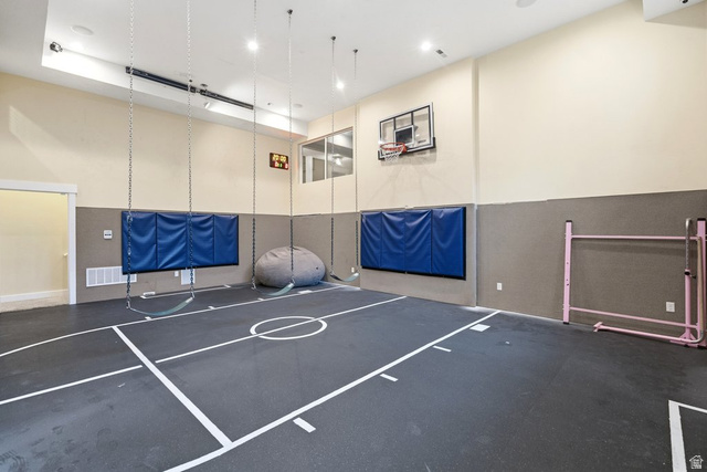 672 Perry Hollow Drive Mapleton, UT 84664 - Photo 82 of 106 Dedicated indoor recreation space featuring a basketball hoop, wall padding, and a marked court