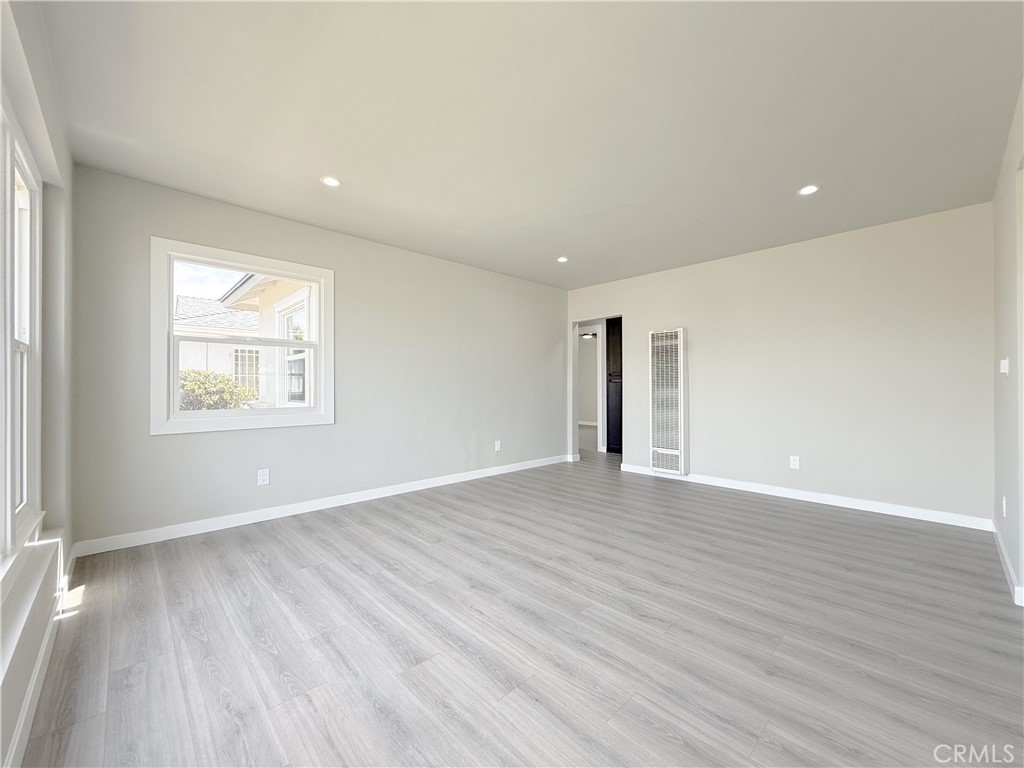 1506 West Stockwell Street Compton, CA 90222 - Photo 11 of 20 a view of an empty room with wooden floor and a window