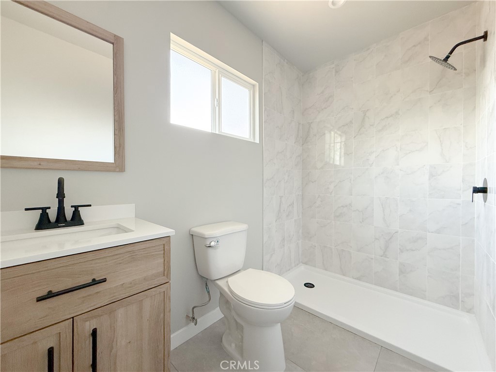 1506 West Stockwell Street Compton, CA 90222 - Photo 13 of 20 a bathroom with a sink a toilet and shower