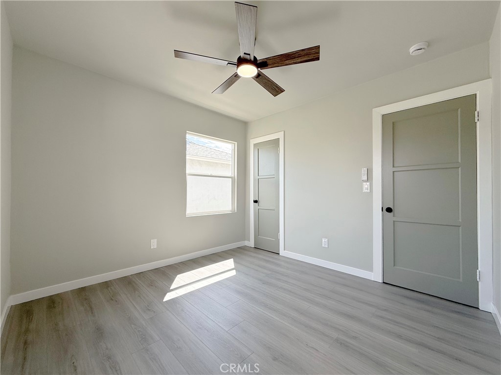 1506 West Stockwell Street Compton, CA 90222 - Photo 14 of 20 an empty room with wooden floor fan and windows