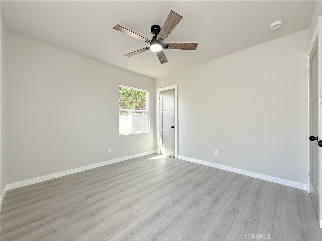 1506 West Stockwell Street Compton, CA 90222 - Photo 15 of 20 a view of an empty room with wooden floor and a ceiling fan
