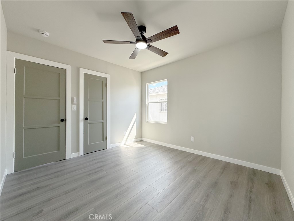 1506 West Stockwell Street Compton, CA 90222 - Photo 16 of 20 wooden floor in an empty room with a window