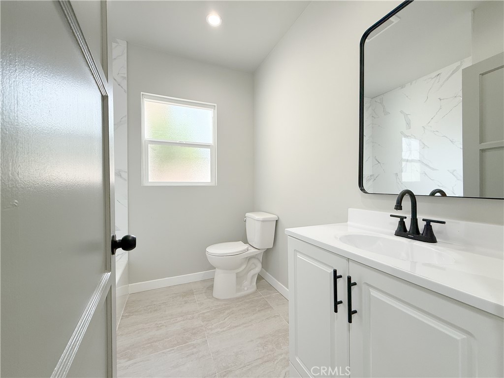 1506 West Stockwell Street Compton, CA 90222 - Photo 17 of 20 a bathroom with a sink toilet and mirror