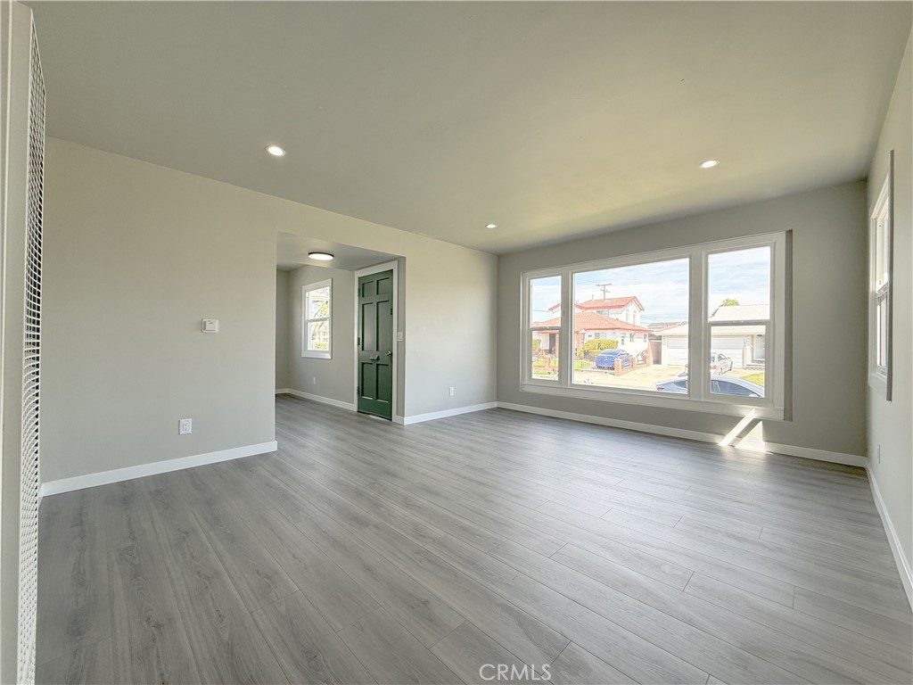 1506 West Stockwell Street Compton, CA 90222 - Photo 3 of 20 an empty room with wooden floor and windows