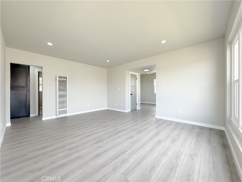 1506 West Stockwell Street Compton, CA 90222 - Photo 5 of 20 a view of an empty room with wooden floor and a window