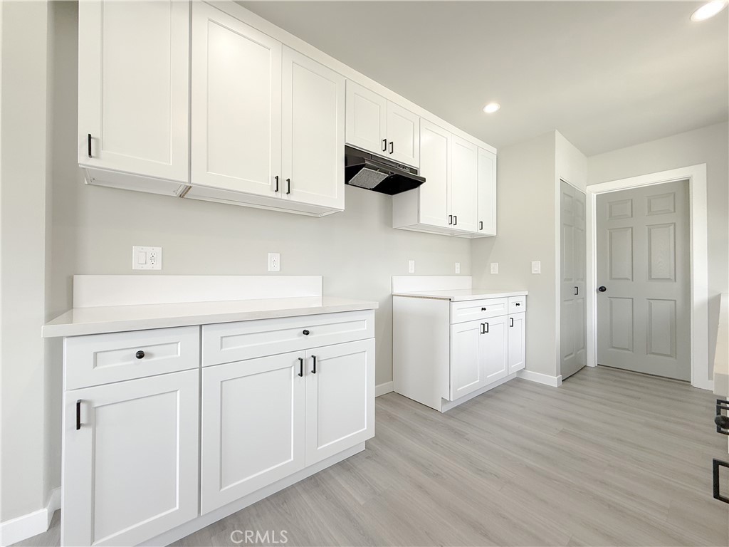 1506 West Stockwell Street Compton, CA 90222 - Photo 7 of 20 a kitchen with white cabinets and white appliances