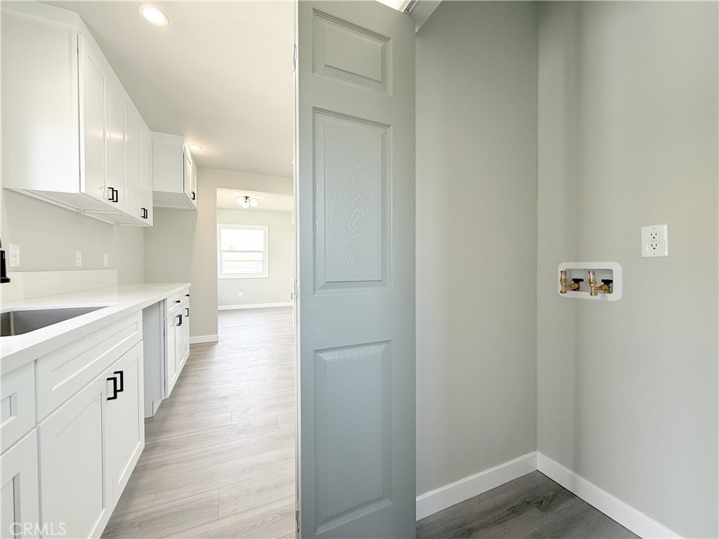 1506 West Stockwell Street Compton, CA 90222 - Photo 9 of 20 a large white kitchen with white cabinets