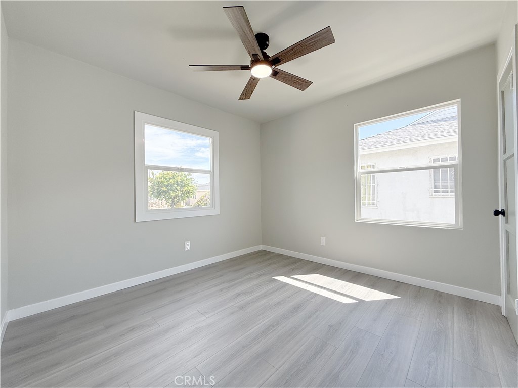 1506 West Stockwell Street Compton, CA 90222 - Photo 10 of 20 an empty room with wooden floor windows and fan