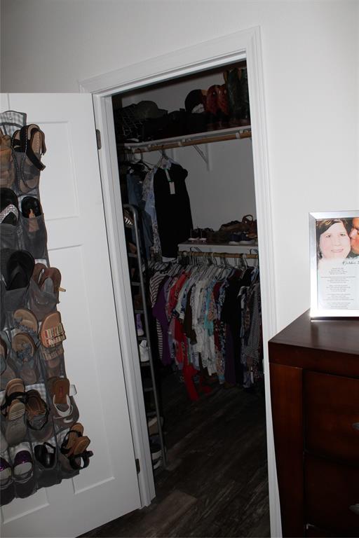2077 A Shawver Road Perrin, TX 76486 - Photo 12 of 35 a view of walk in closet with clothes and shoes