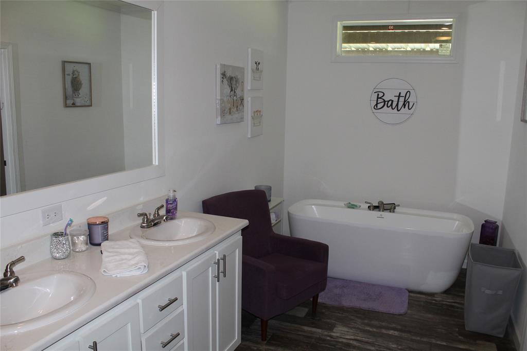 2077 A Shawver Road Perrin, TX 76486 - Photo 13 of 35 a bathroom with a sink and a mirror