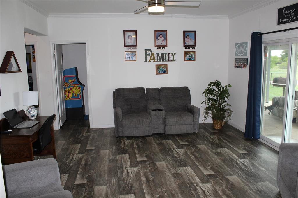 2077 A Shawver Road Perrin, TX 76486 - Photo 9 of 35 a living room with furniture and wooden floor
