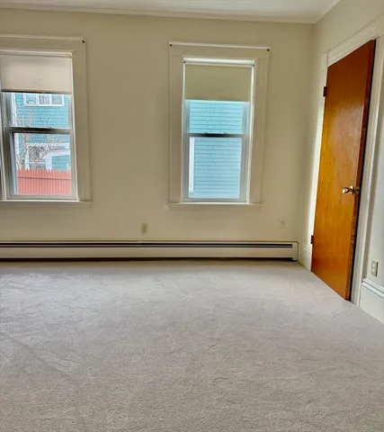 a view of an empty room and a window