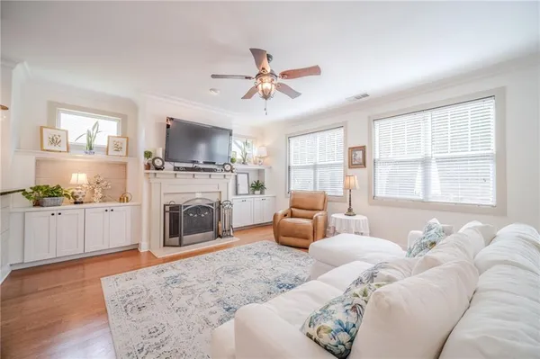 a living room with furniture a fireplace and a flat screen tv
