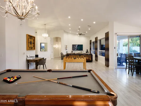 a room with furniture pool table and windows