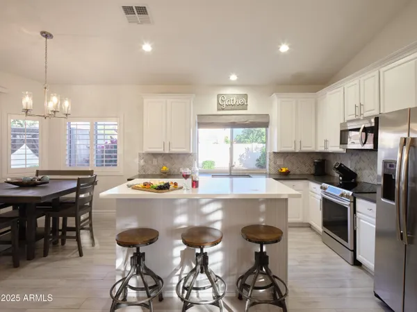 a kitchen with a sink a stove and cabinets