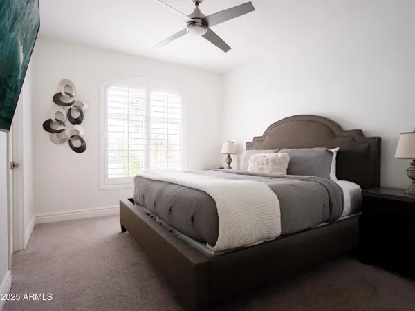 a bedroom with a bed and a lamp