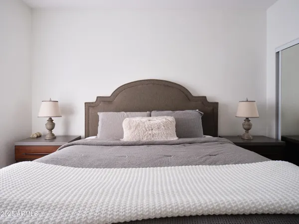 a bedroom with a bed and a flat screen tv