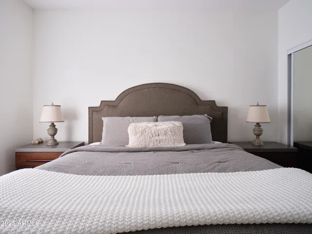a bedroom with a bed and a flat screen tv