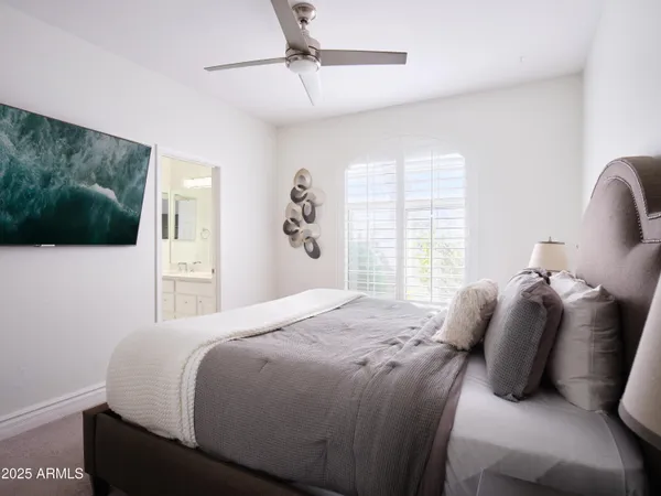 a bedroom with a bed and a lamp