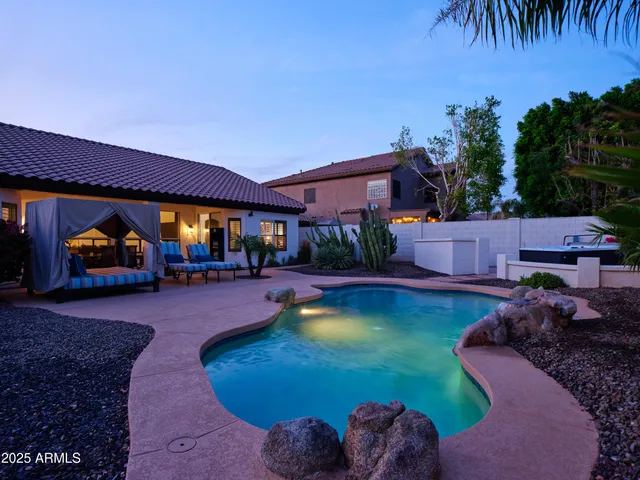 a view of a house with pool yard and outdoor seating