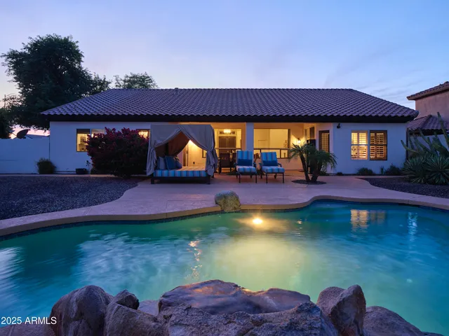 a view of a house with backyard porch and sitting area