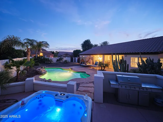 a swimming pool with outdoor seating and yard