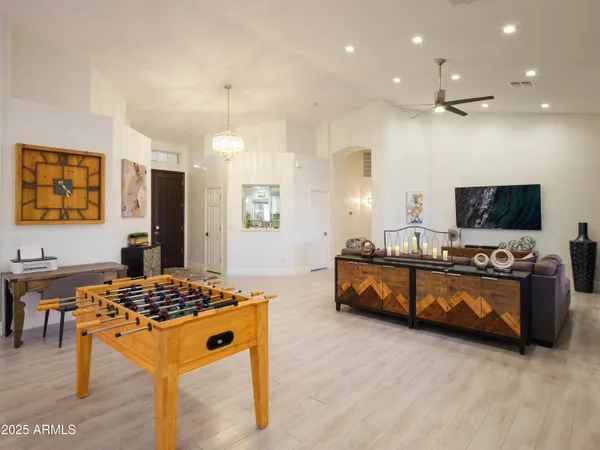 a living room with large mirror furniture and a flat screen tv