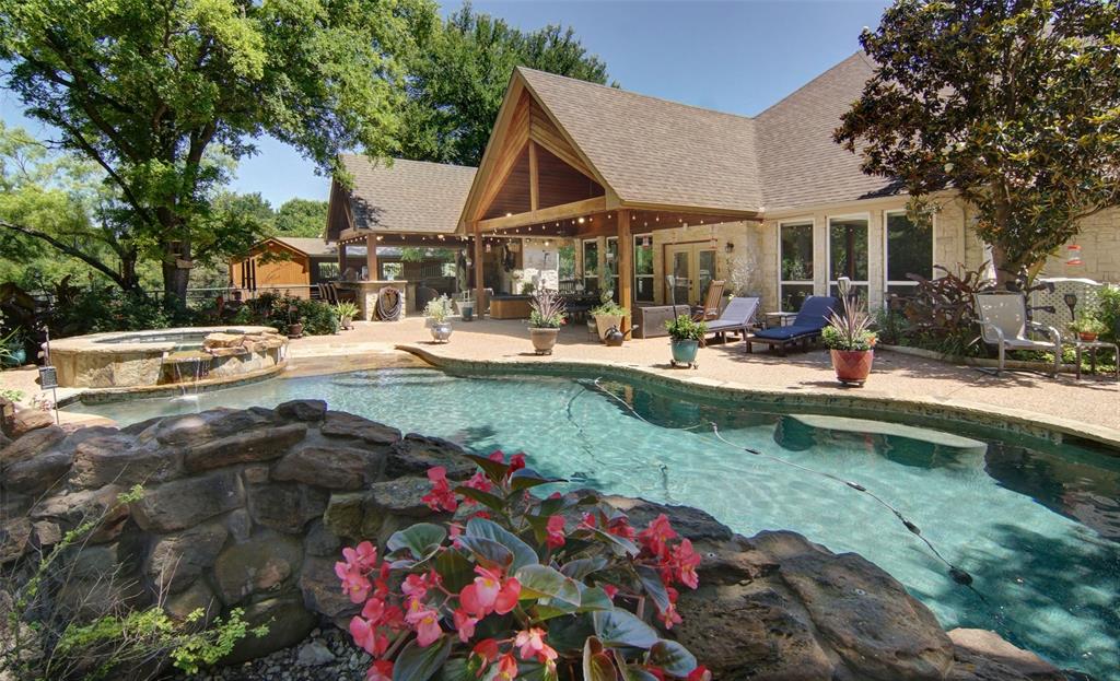 a view of a house with backyard sitting area and swimming pool