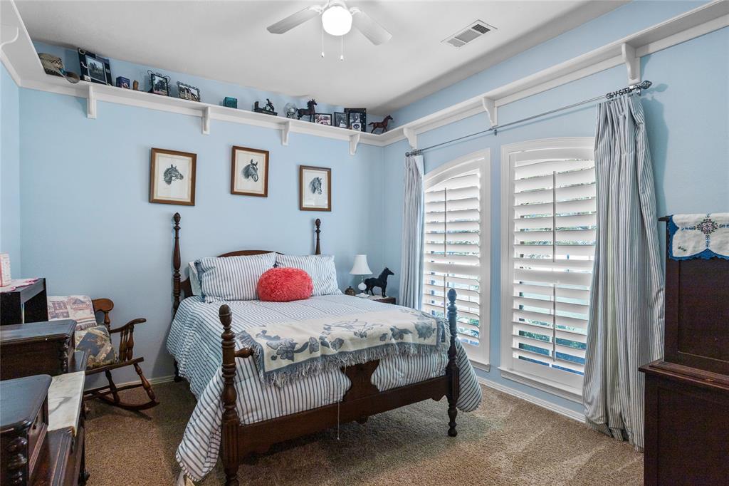 110 Bent Creek Ranch Court Fort Worth, TX 76126 - Photo 14 of 40 a bedroom with a bed and a table