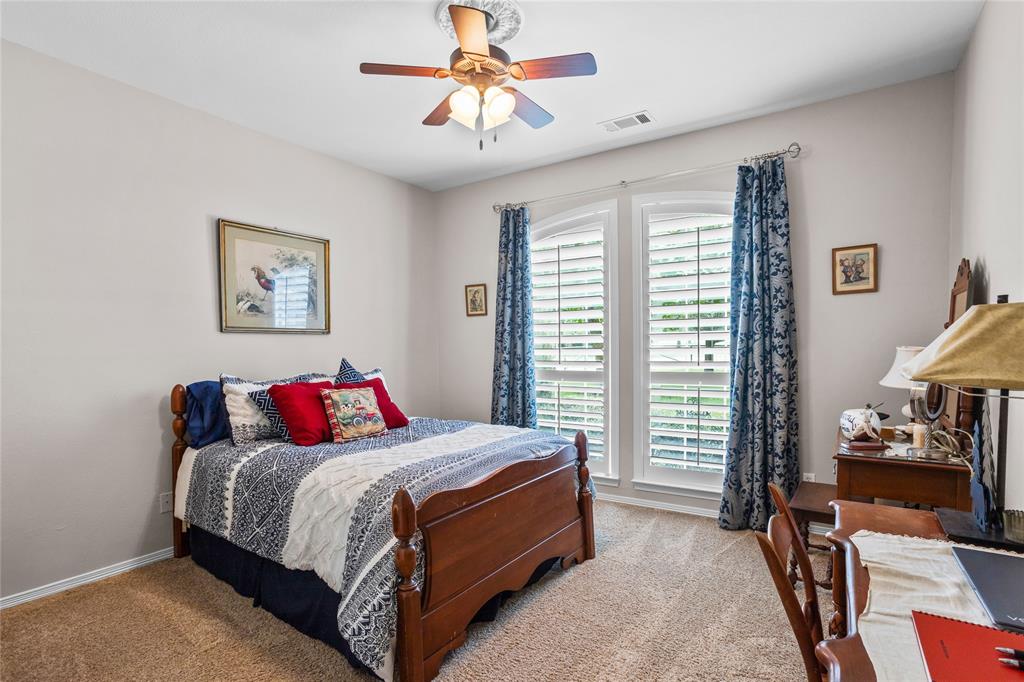 110 Bent Creek Ranch Court Fort Worth, TX 76126 - Photo 15 of 40 a bedroom with a bed and a chandelier