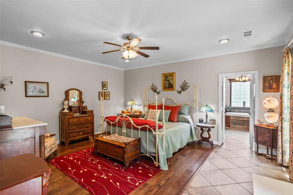 110 Bent Creek Ranch Court Fort Worth, TX 76126 - Photo 17 of 40 a bedroom with furniture and a chandelier