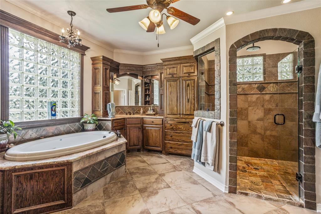 110 Bent Creek Ranch Court Fort Worth, TX 76126 - Photo 19 of 40 a bathroom with a sink a toilet a mirror and shower