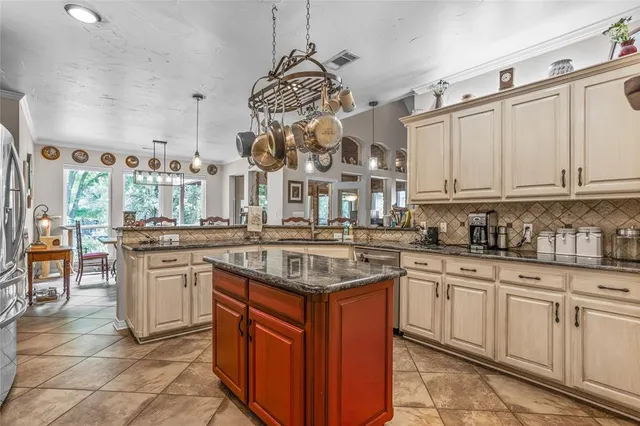 a kitchen with stainless steel appliances granite countertop a sink and cabinets