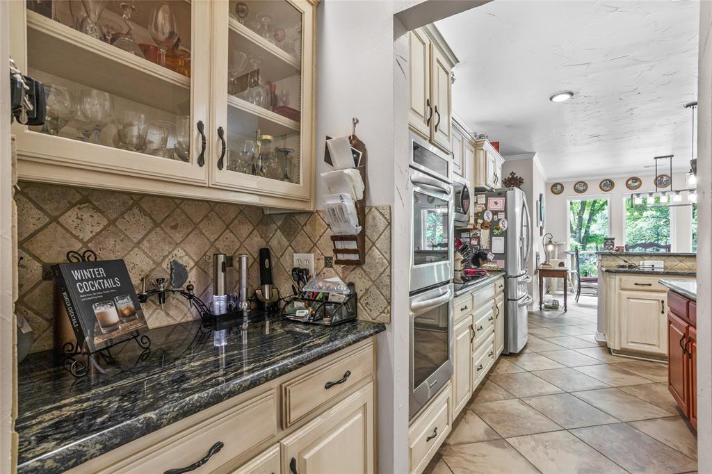 110 Bent Creek Ranch Court Fort Worth, TX 76126 - Photo 10 of 40 a kitchen with stainless steel appliances kitchen island granite countertop a refrigerator and a stove
