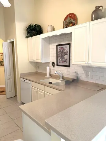 a kitchen with a sink a stove and a refrigerator