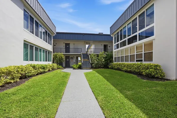 a front view of a building with garden