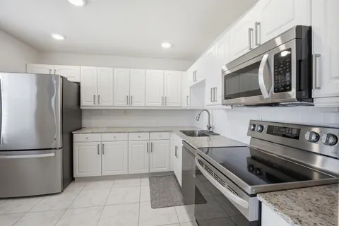 a kitchen with a refrigerator sink and microwave