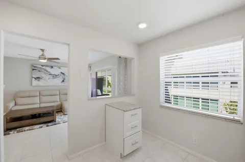 a bathroom with a granite countertop sink a toilet and a mirror