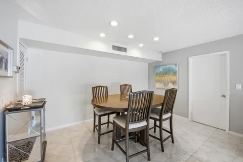a view of a dining room with furniture and a large window