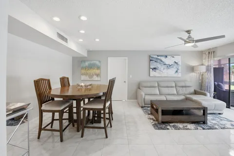 a view of a dining room with furniture and window