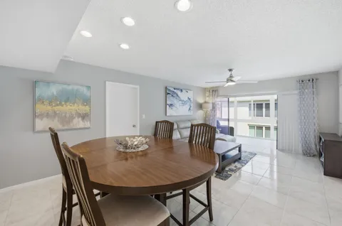 a living room with furniture a large window and a clock