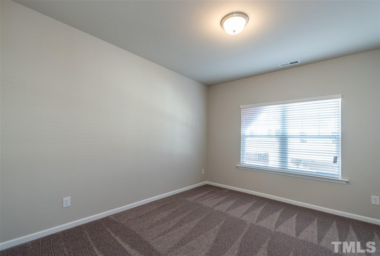 6339 Grace Lily Drive, Unit 18 Raleigh, NC 27607 - Photo 14 of 23 an empty room with a window