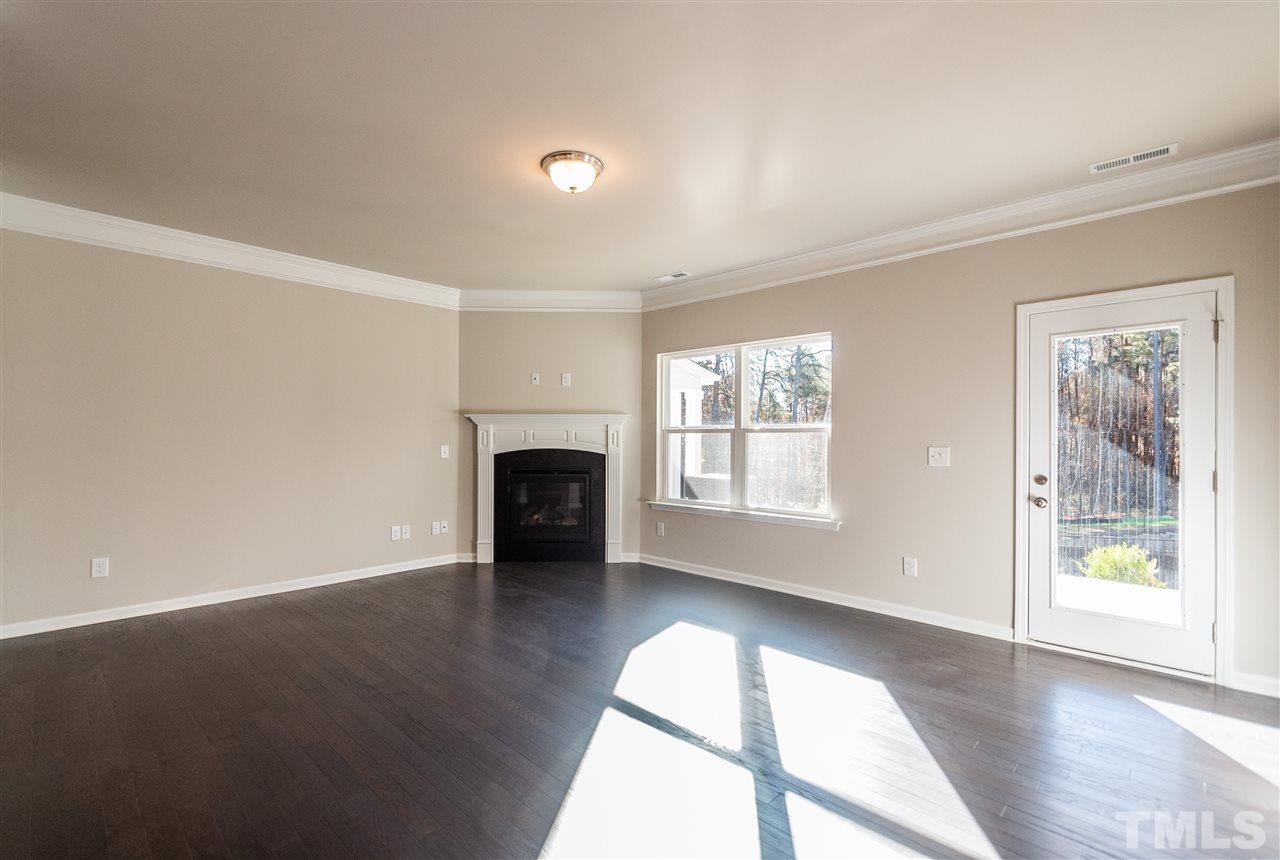 6339 Grace Lily Drive, Unit 18 Raleigh, NC 27607 - Photo 8 of 23 wooden floor in an empty room with a window