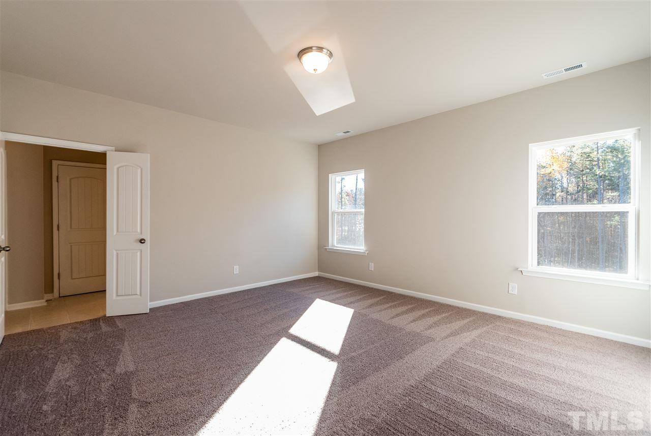 6339 Grace Lily Drive, Unit 18 Raleigh, NC 27607 - Photo 9 of 23 a view of an empty room with a window
