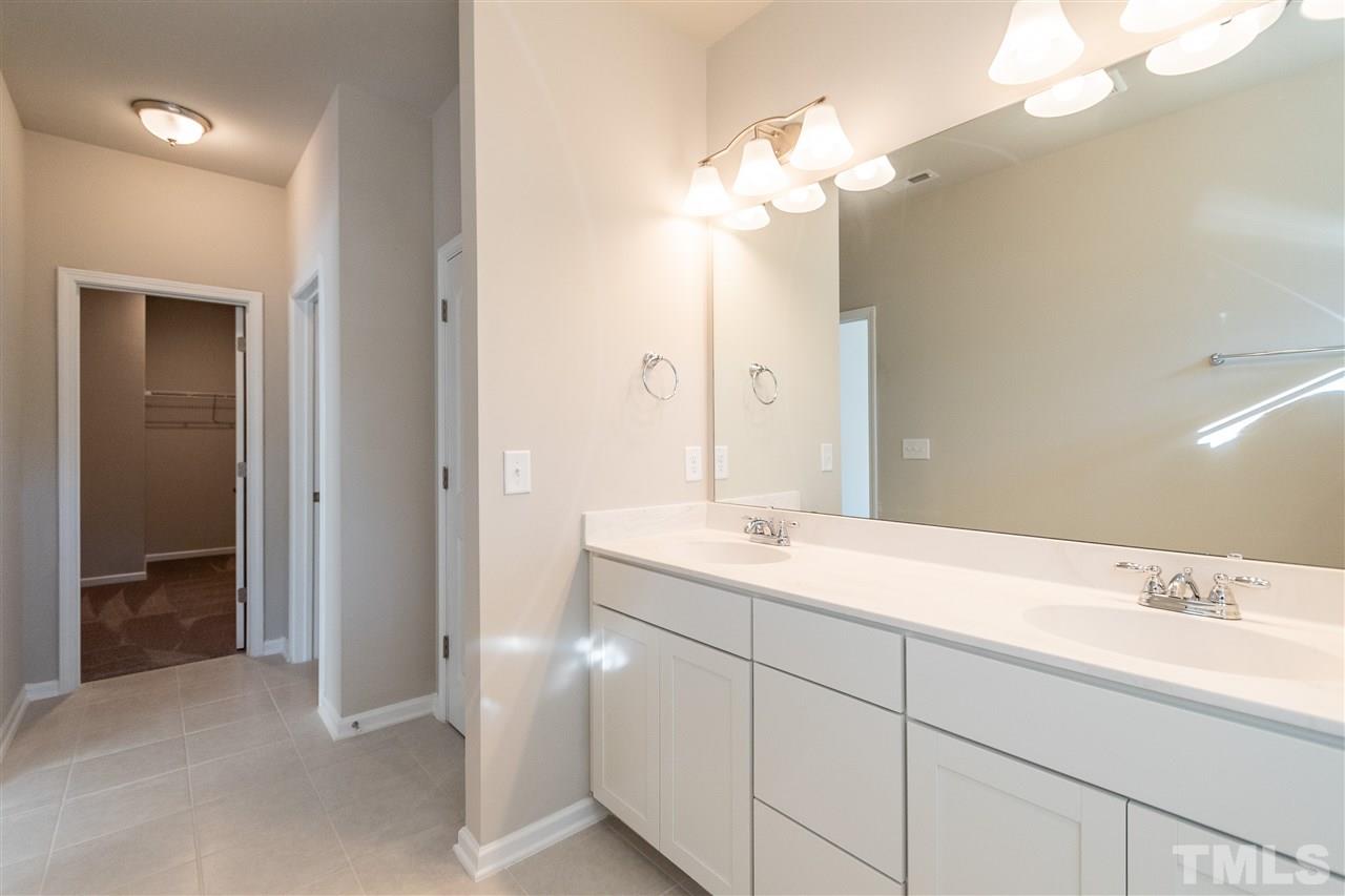 6339 Grace Lily Drive, Unit 18 Raleigh, NC 27607 - Photo 10 of 23 a bathroom with a sink and a mirror