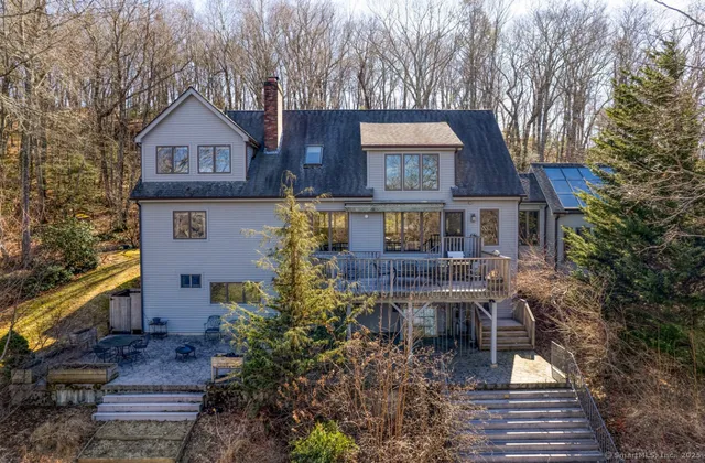 a front view of a house with yard and trees