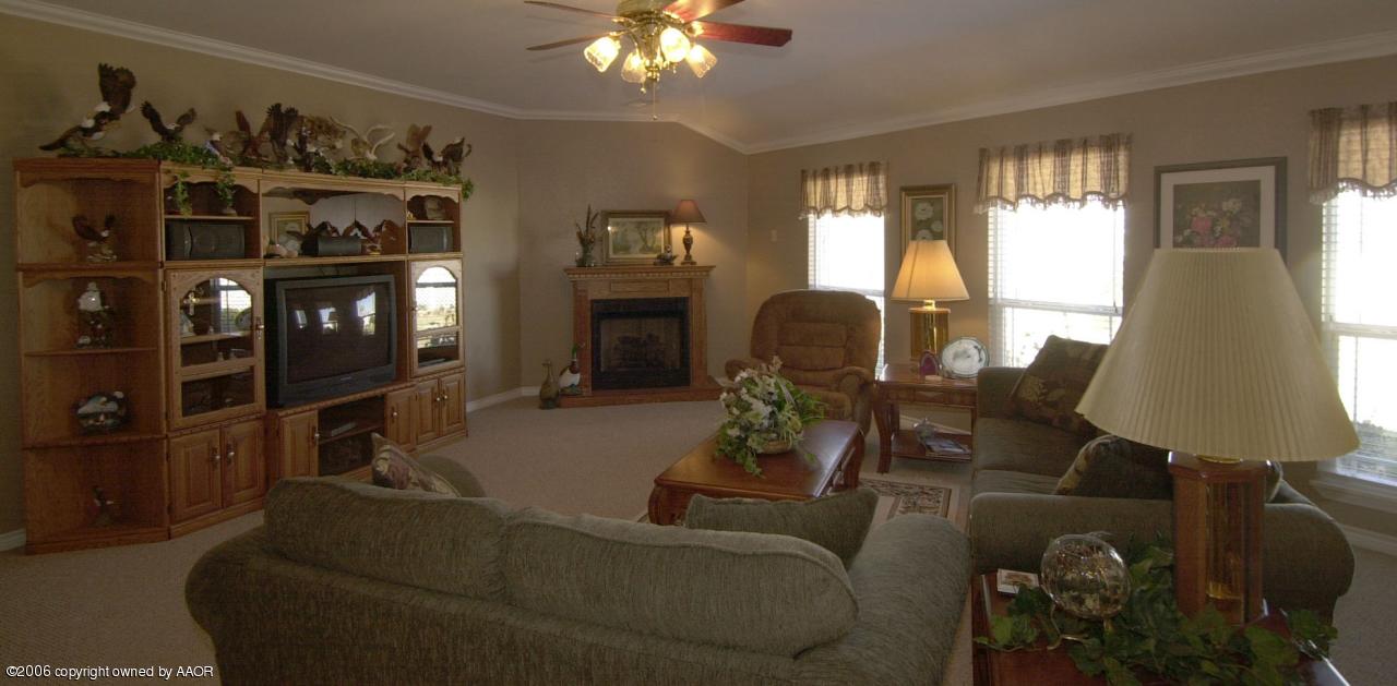 8800 Red Wing Road Amarillo, TX 79119 - Photo 4 of 15 a living room with furniture a lamp and a window