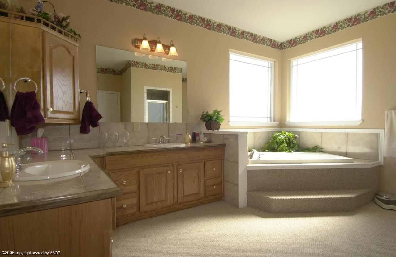 8800 Red Wing Road Amarillo, TX 79119 - Photo 7 of 15 a bathroom with a tub sink and mirror